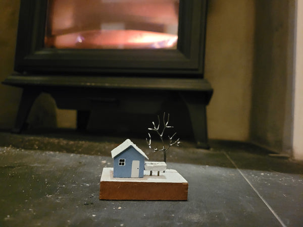 Little winter cottage with tree