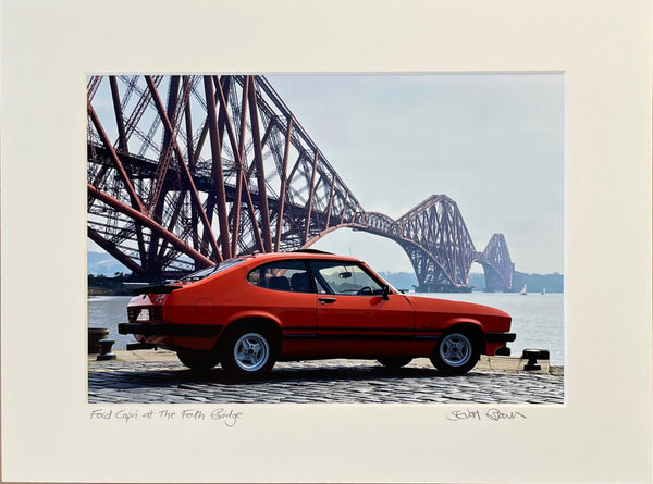 a red ford capri parked under the forh road rail bridge 