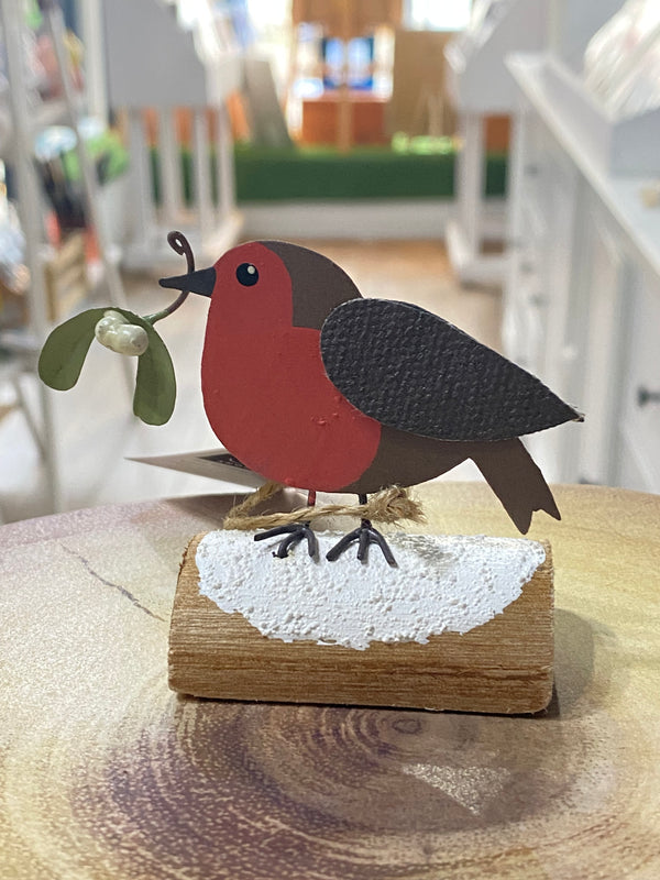 Wooden birdhouse with a red robin design on a wooden post.