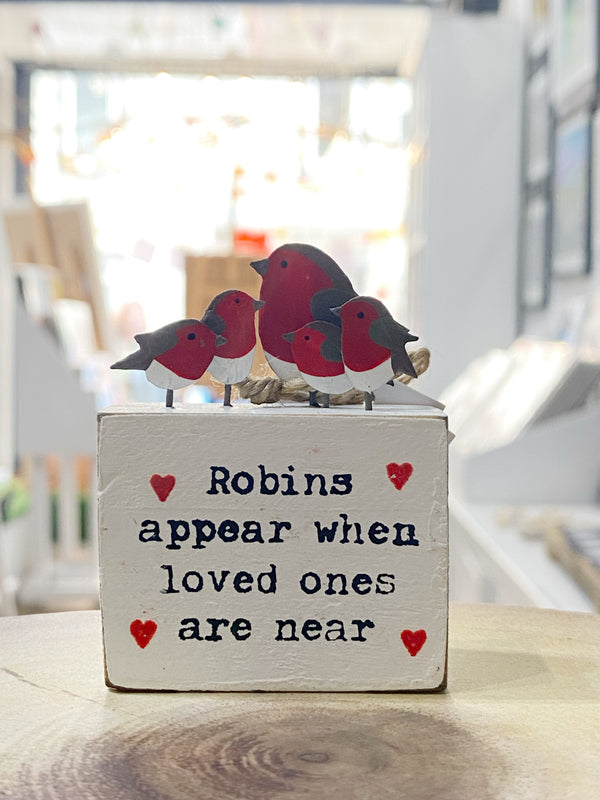 Decorative wooden box with three bird figurines and text saying loved ones are near when roins appear
