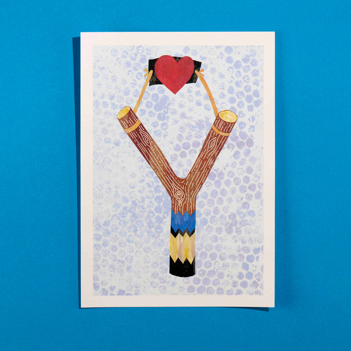 A print of a catapult with a love heart with textured background
