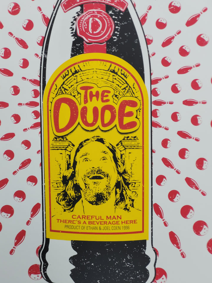 The dude from the big lebowski featured on a bottle of Kahlua with the title The Dude and his famous line saying careful man there's a beveridge here