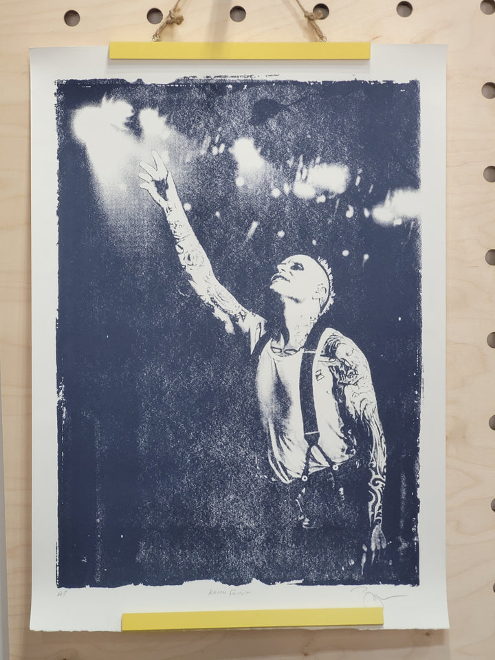 monochrome screen print of keith flint of the prodigy on stage under spotlights 